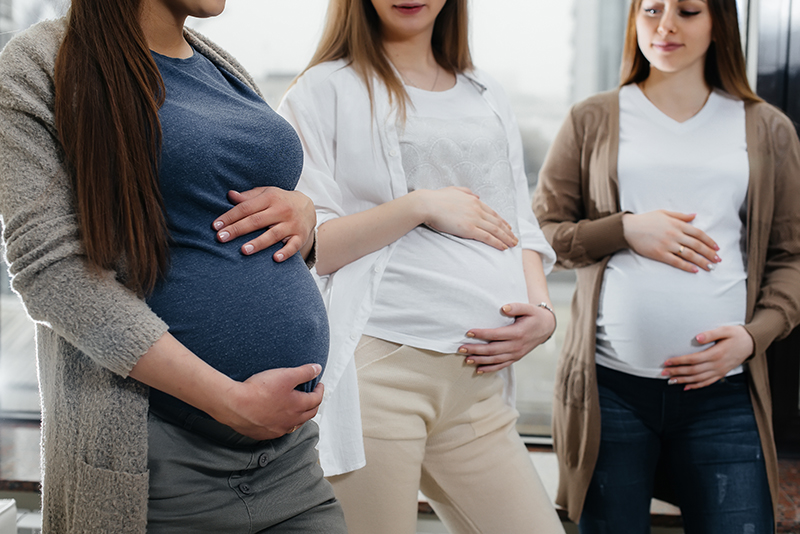 A group of young pregnant girls communicate in the prenatal class. Care and consultation of pregnant women.